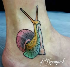 a colorful snail tattoo on the foot