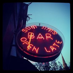 a neon sign that says sun times bar open late