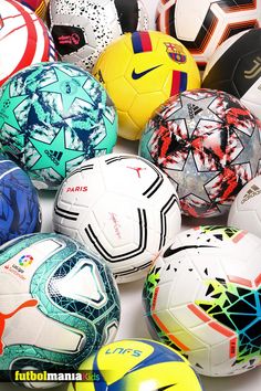 a pile of soccer balls sitting next to each other