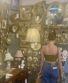 a woman standing in front of a wall full of mirrors