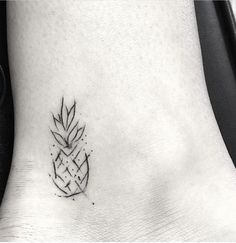 a small pineapple tattoo on the ankle