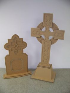 two cardboard crosses sitting next to each other