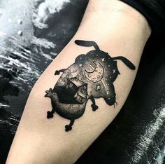 a person with a tattoo on their arm that has an image of a cat and dog