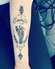 a person with a tattoo on their arm that says emmet and an arrow in the center