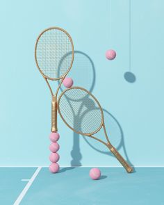 two tennis racquets and balls on a blue surface