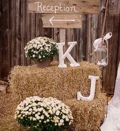 a hay bale with flowers and letters on it