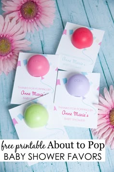 three printable baby shower favors with pink daisies in the background and text overlay that reads free printable about to pop baby shower favors