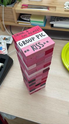 a stack of pink blocks sitting on top of a wooden desk