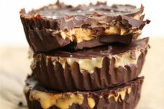 three pieces of chocolate are stacked on top of each other with caramel drizzle