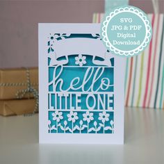 a card with the words hello little one printed on it and a gift bag next to it