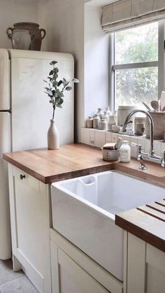 a kitchen with a sink, refrigerator and window