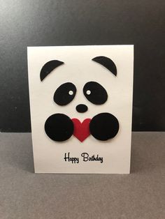 a card with a panda face on it and the words happy birthday written in black