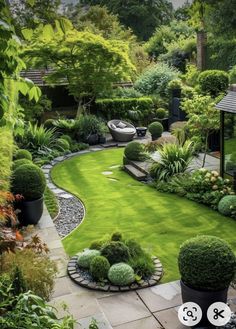 an outdoor garden with green grass and plants in the center, surrounded by trees and bushes