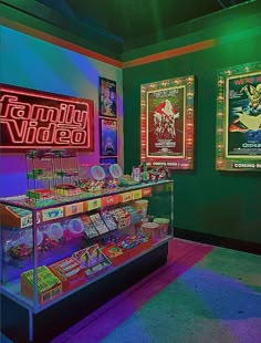 a brightly lit video game shop with neon signs on the wall and posters behind it