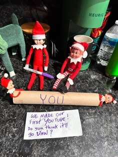 two elfs are posed next to a sign that says you made out of toilet paper