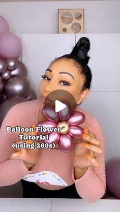 the woman is holding balloons in front of her face and making an expression with her hands