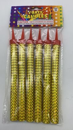 yellow plastic candy cones with red tops in celloine packaging on a white tablecloth