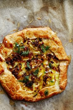 a pizza with toppings sitting on top of a piece of paper