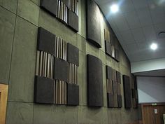 the wall is made up of many different pieces of wood and metal strips on it