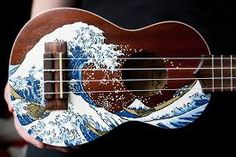 a ukulele with an image of a man's face on it