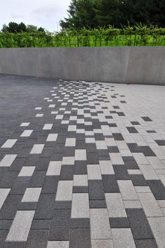 a black and white checkerboard pattern is on the ground next to a wall