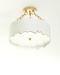 a white and gold chandelier hanging from the ceiling