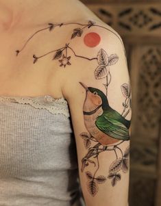 a woman with a bird tattoo on her arm