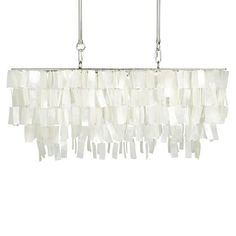 a white chandelier hanging from the ceiling with glass blocks on it's sides