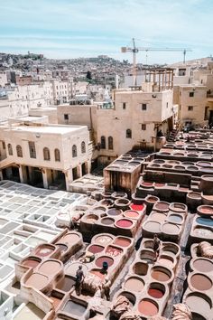 many pots are stacked on top of each other in the middle of an old city