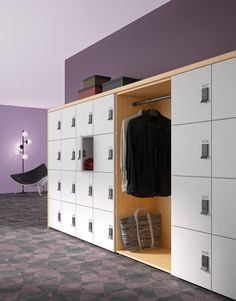 a room with several white lockers and purple walls