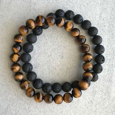 Product Description: Condition: 100% new and high quality Material: Matte Black Onyx (10mm), Lava (10mm), Tigers Eye (10mm) & Hematite (9mm) Color: As the picture shown Size: (approx) 6.5-7.5" (Elastic) Package Included: 1 OR 2 Pcs Bracelets   Add this beautiful piece to your wardrobe. Great bracelet for everyday use. Dress it up for special occasions. Makes a great gift for yourself or for a special someone.   The unique and innovative designs are handcrafted and produced with the finest care. For gift-giving occasions: tourism memorial, birthday, wedding, advertising promotions, business gifts, holiday, after the trade fair It's a perfect accessory, also a good gift to your friends It will make you beautiful on picture. Suitable for any season.   High quality in EU and US quality standar Tiger Eye Bracelet Men, Double Bracelet, Slide Bracelet, Tiger Eye Bracelet, Tigers Eye Gemstone, Onyx Bracelet, Tiger Eye Beads, Onyx Gemstone, Gemstone Beaded Bracelets