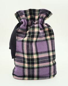 Handmade with care and attention to detail, this hot water bottle cover is the ideal accessory during colder seasons. The purple, green & black brushed cotton plaid fabric is both soft and sturdy. This hot water bottle cover is hand made, by me, in my home using professional sewing techniques.  What makes it different than most hot water bottle covers? This hot water bottle cover is fully satin lined and insulated, which means no exposed seams, and longer-lasting heat from your hot water bottle. I choose fabrics that are beautiful and durable, in this case a cozy cotton plaid.   *NEW UPDATE* Don't have a hot water bottle? Select the option to add natural rubber hot water bottle to go with your new hot water bottle cover! Features: Draw-cord closure: easily insert or remove your standard-si Bottle Covers, Hot Water Bottle Cover, Water Bottle Covers, Exposed Seams, Hot Water Bottle, Bottle Cover, Heat Pack, Purple And Green, Plaid Fabric