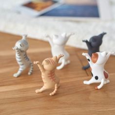 small toy figurines sitting on top of a wooden table