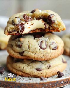 chocolate chip cookies stacked on top of each other with white icing and chocolate chips