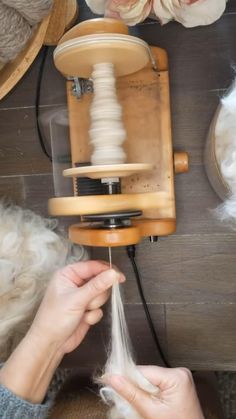 someone is spinning yarn on an old fashioned sewing machine