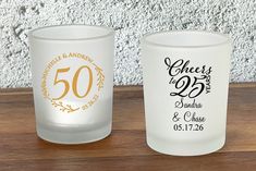 two personalized shot glasses sitting on top of a wooden table next to each other