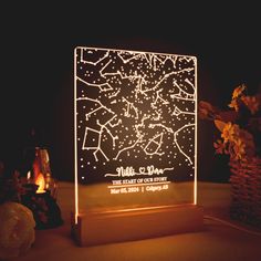 an illuminated star map on a wooden stand