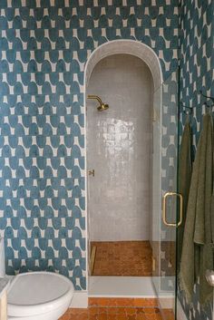 a bathroom with blue and white patterned walls