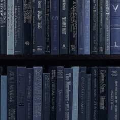 a book shelf filled with lots of blue books