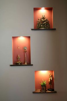 three shelves with decorative items on them in a room that is painted red and white