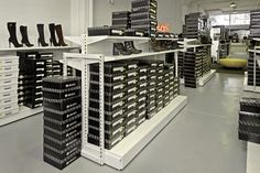 the inside of a shoe store filled with lots of black and white boxes