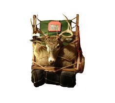 an animal is sitting in a sleigh with two antlers on it's back