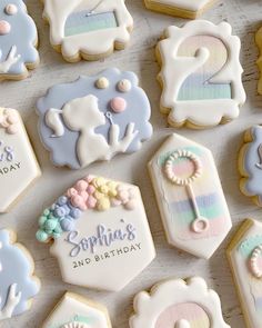 decorated cookies are arranged on a table for a baby's first birthday party,