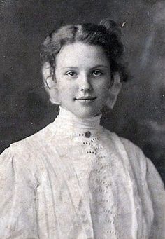 an old black and white photo of a young woman