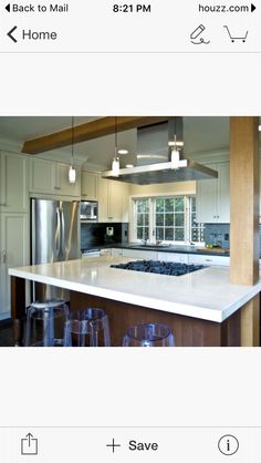 a kitchen with an island, stove and oven in it's center area next to two stools