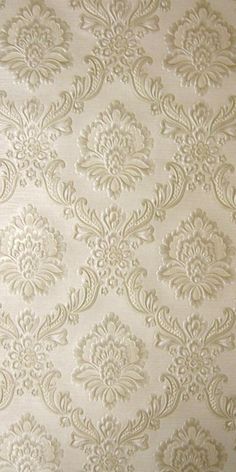 a white wallpaper with an ornate design on it