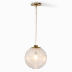 a glass ball hanging from a brass colored light fixture with a white wall in the background