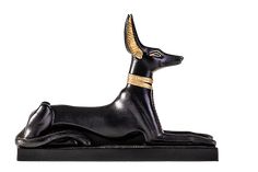 an egyptian style black statue with gold horns on it's head and legs, sitting in front of a white background