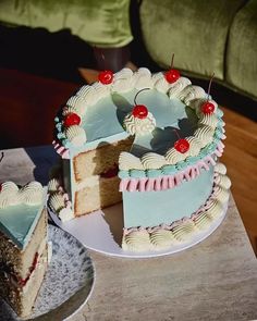 a cake that has been cut into pieces and is sitting on a table with another piece missing