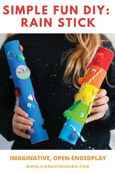 a girl holding two colorful paper toys with the words, simple fun diy rain stick